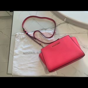 Michael Kors crossbody pink leather bag.
